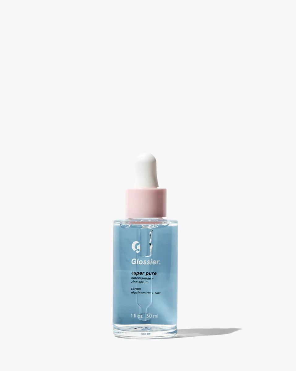 Glossier Super Pure Niacinamide Serum in a purple-tinted glass dropper bottle