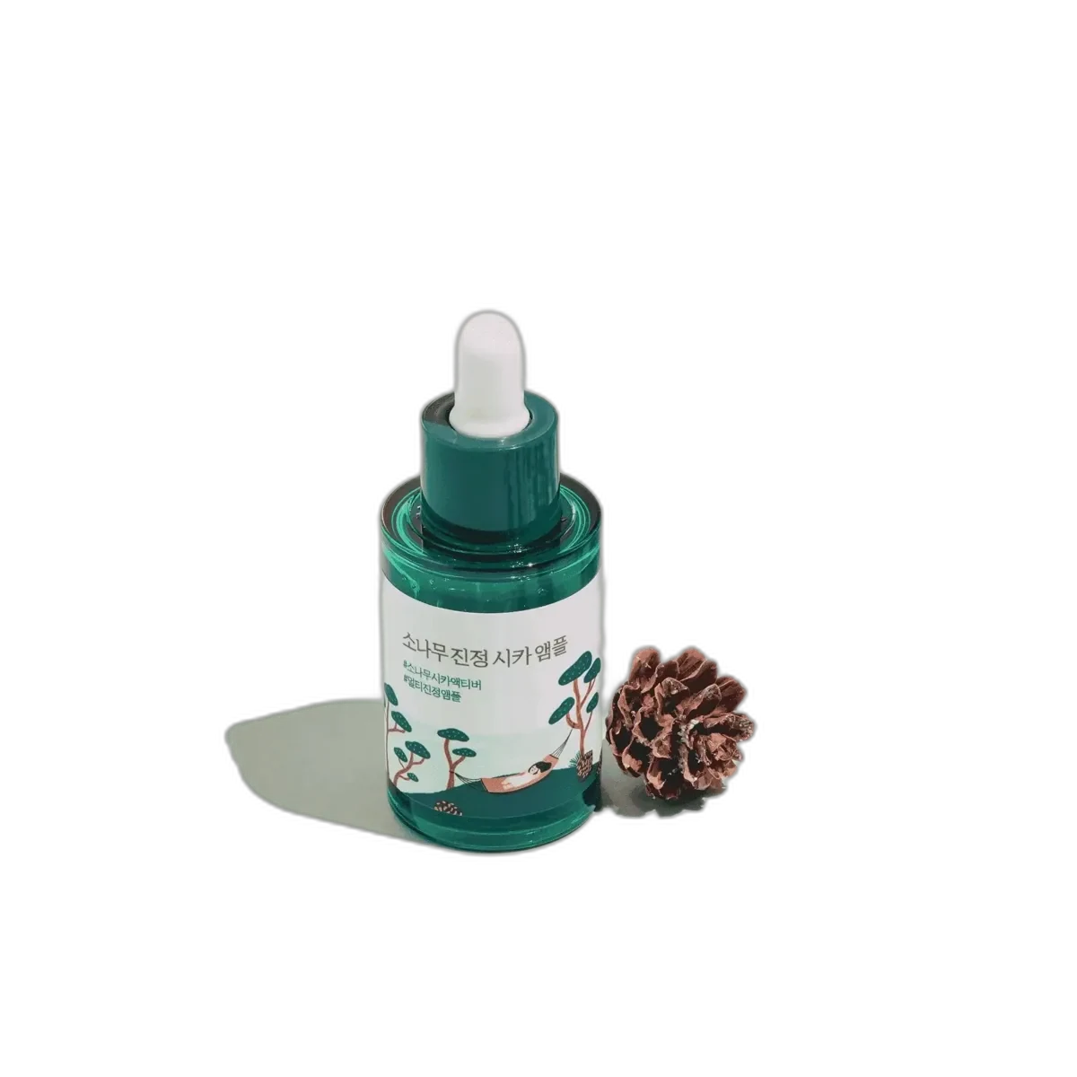Round Lab Pine Tree Calming Cica Ampoule in a small green and white bottle with pump